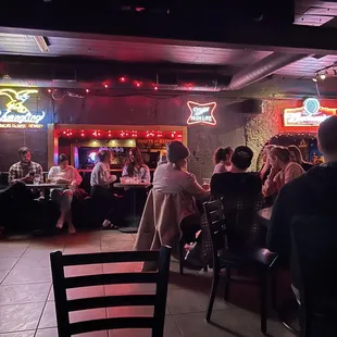 people sitting at tables in a restaurant