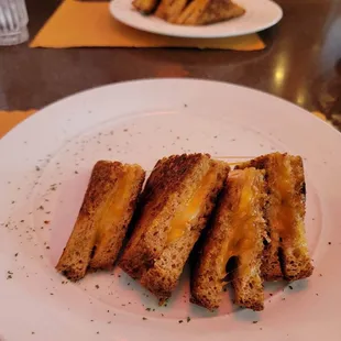 a plate of grilled cheese sandwiches