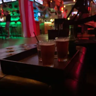 two glasses of beer on a tray