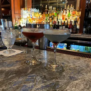 two glasses of wine on a bar