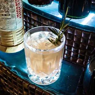 a gin cocktail with a sprig of rosemary
