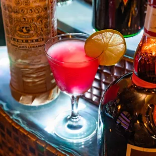 a glass of alcohol and a bottle of liquor