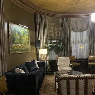 a living room with a couch and chairs