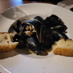 Mussels appetizer. All of it amazing: broth, bread, mussels. So good!