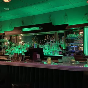 a bar with green lights