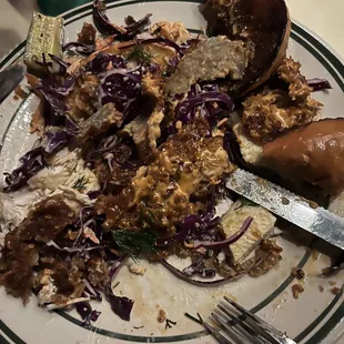 Fried chicken sandwich cut up in order to consume.