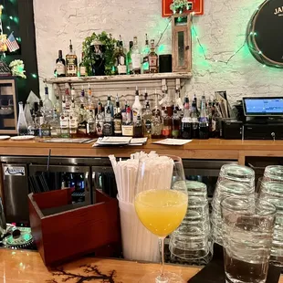 a glass of orange juice on the bar