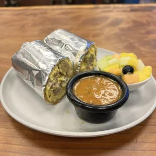 a burrito with a side of fruit