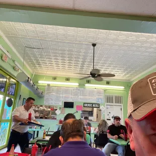 a man wearing a hat in a restaurant