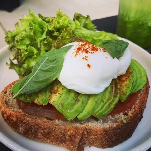 n avocado toast with poached eggs and lettuce