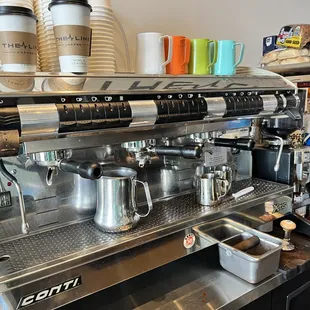 a coffee machine and cups