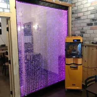 a vending machine and a brick wall