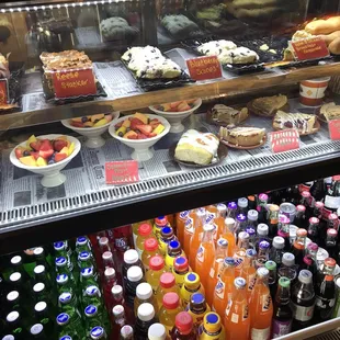 a display case full of drinks and desserts