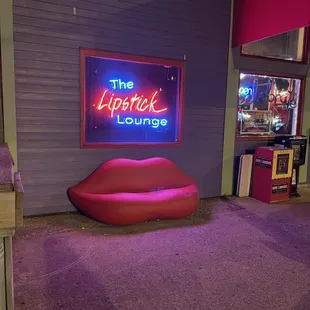 a neon sign in the corner of a room