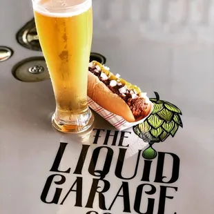 a hot dog and a glass of beer