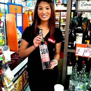 a woman holding a bottle of sun