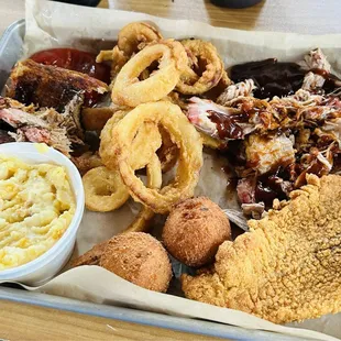 Surf and Turf with pork and catfish, cheese grits and onion rings