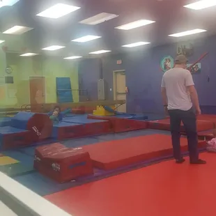 Part of the little gym. They have uneven bars, balance beams, a party room schedules, for parents and children