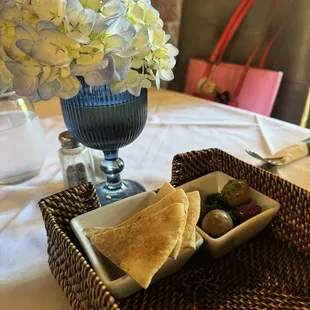 Olives and chips that accompany the meal.