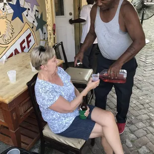 a man pouring a glass of wine