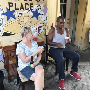 a man and a woman sitting on a bench