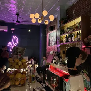 people at a bar with purple lighting