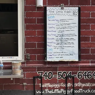 a menu on a brick wall