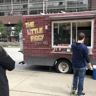 a man standing in front of a food truck