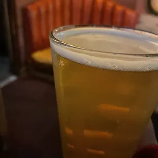 a person holding a glass of beer