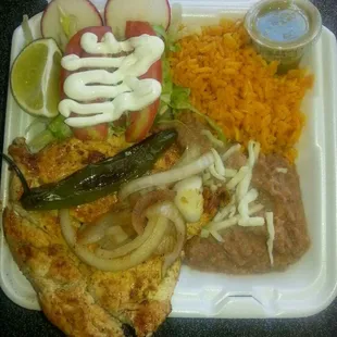 Chicken breast grilled, served with rice,  beans and salad.