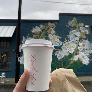 Lavender latte and wall art by the side of the building