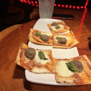 four slices of pizza on a plate