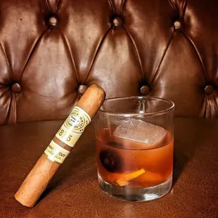 a cigar and a glass of whiskey