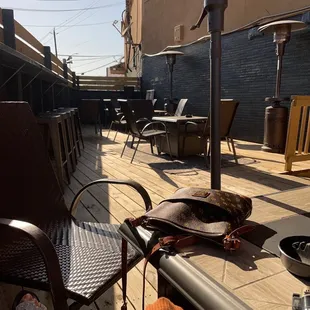 a patio with chairs and an umbrella