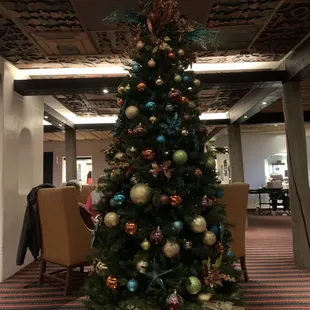 a decorated christmas tree in a hotel lobby