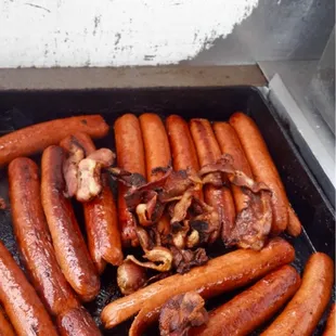 a bunch of sausages being cooked