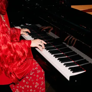 a woman playing a piano