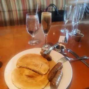 Short stack Pancakes with breakfast sausage and apple cider mimosa