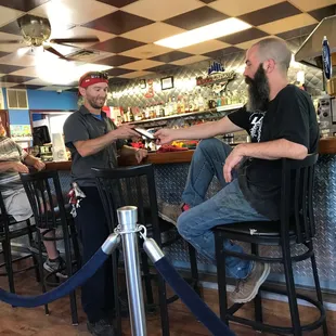 two men sitting at a bar