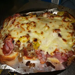 a pizza with meat and cheese