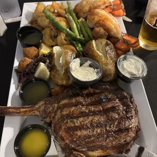 tomahawk dinner!! 40 ounce tomahawk steak two lobster tails a pound of shrimp, hush puppies asparagus two baked potatoes