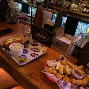 two trays of food on the bar