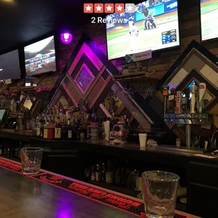  a bar with multiple televisions