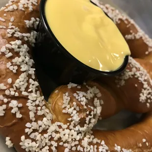 a pretzel with a dipping sauce