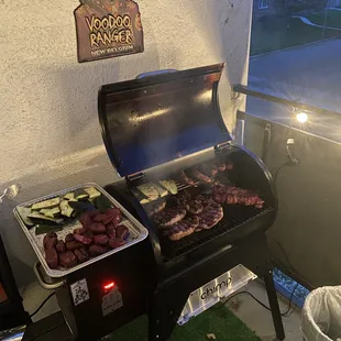 a grill with meat and vegetables on it