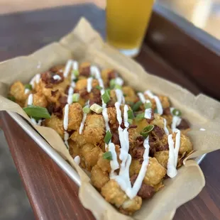 Totchos - loaded tator tot nachos loaded with bacon, cheese, sour cream, and chives.

Late night menu exclusive!