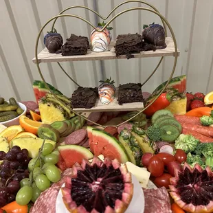 Charcuterie board with brownies and chocolate covered strawberries