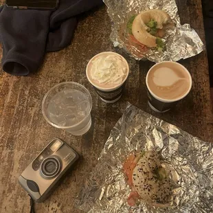 An everything bagel sandwich, plain bagel sandwich, hot vanilla latte and a hot chocolate