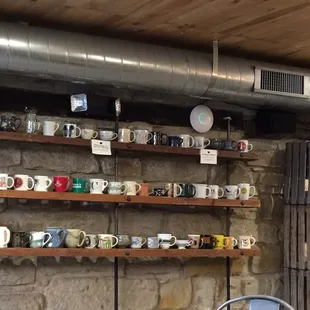 a shelf of coffee mugs