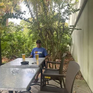 a man sitting at a table outside